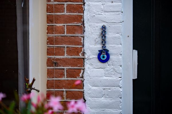 evil eye guard  hanging on the front wall of a house as protection- ZeroKaata Studio