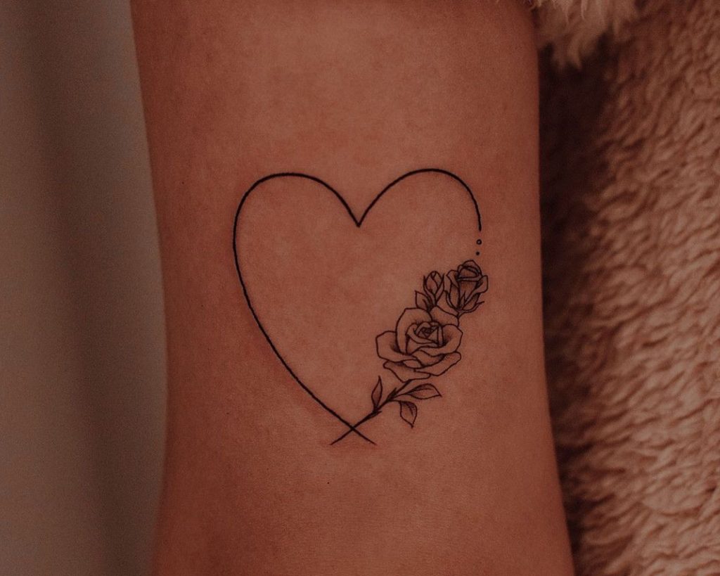A heart tattoo with roses on the right side as an inspiration for heart for tattoo designs for you