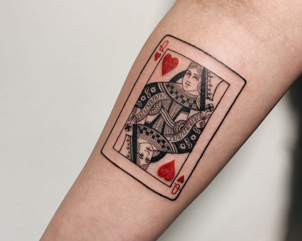 An exact replica of "Queen of hearts tattoo" design on the forearm of a man as an inspiration for heart for tattoo designs for you